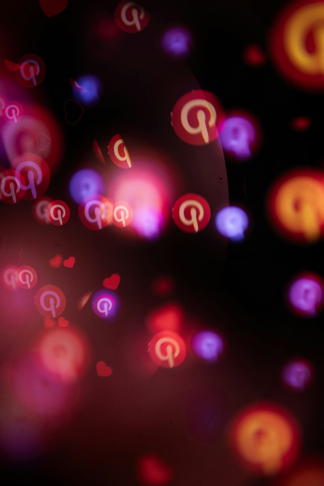 pinterest-logos-and-hearts-float-in-a-dark-bokeh-background-6w3xsiejsxc